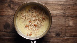 Almond slices simmering in butter and sugar for Bienenstich topping